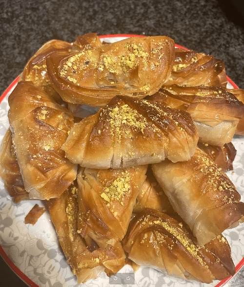 syrup-soaked golden puff pastry stacked on a plate