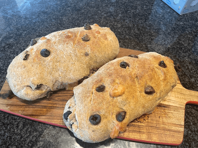 loaf of soft sourdough bread filled with generous olives & cheese