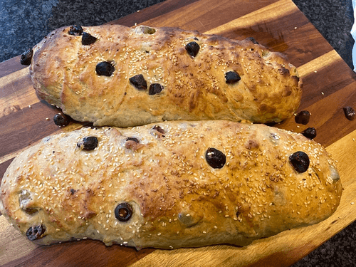 loaf of soft sourdough bread filled with generous olives